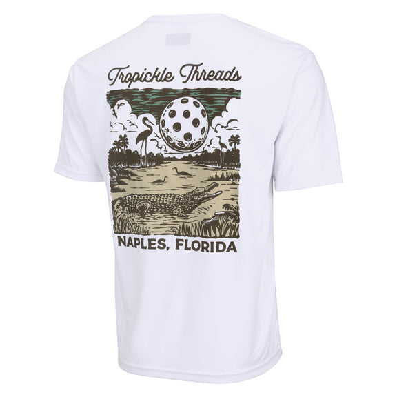 Introducing our latest creation: the Gator T-shirt. With its unique design featuring a gator under a full moon made of a giant Pickleball, this shirt adds Florida charm to your game. Crafted and printed in Naples, it blends style and performance seamlessly. Discover this exclusive addition to our collection of shirts, hats, and sportswear perfect for tournaments and everyday attire.