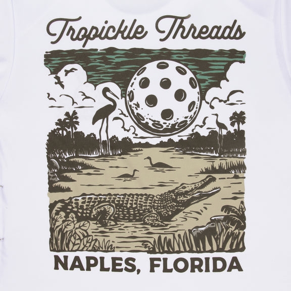 Introducing our latest creation: the Gator Women's Pickleball T-shirt. With its unique design featuring a gator under a full moon made of a giant Pickleball, this shirt adds Florida charm to your game. Crafted and printed in Naples, it blends style and performance seamlessly. Discover this exclusive addition to our collection of shirts, hats, and sportswear perfect for tournaments and everyday attire.